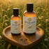 Sliquid Organics Silk hybrid lube bottles on a wooden tray in a meadow