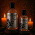 Sliquid Spark bottles on stones beside candles
