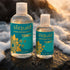 Two Sliquid Tsunami bottles on a coastal rock in warm light