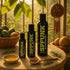 SPUNK Natural lubricant bottles on a sunlit table beside a basket of fruit and a bowl of oil